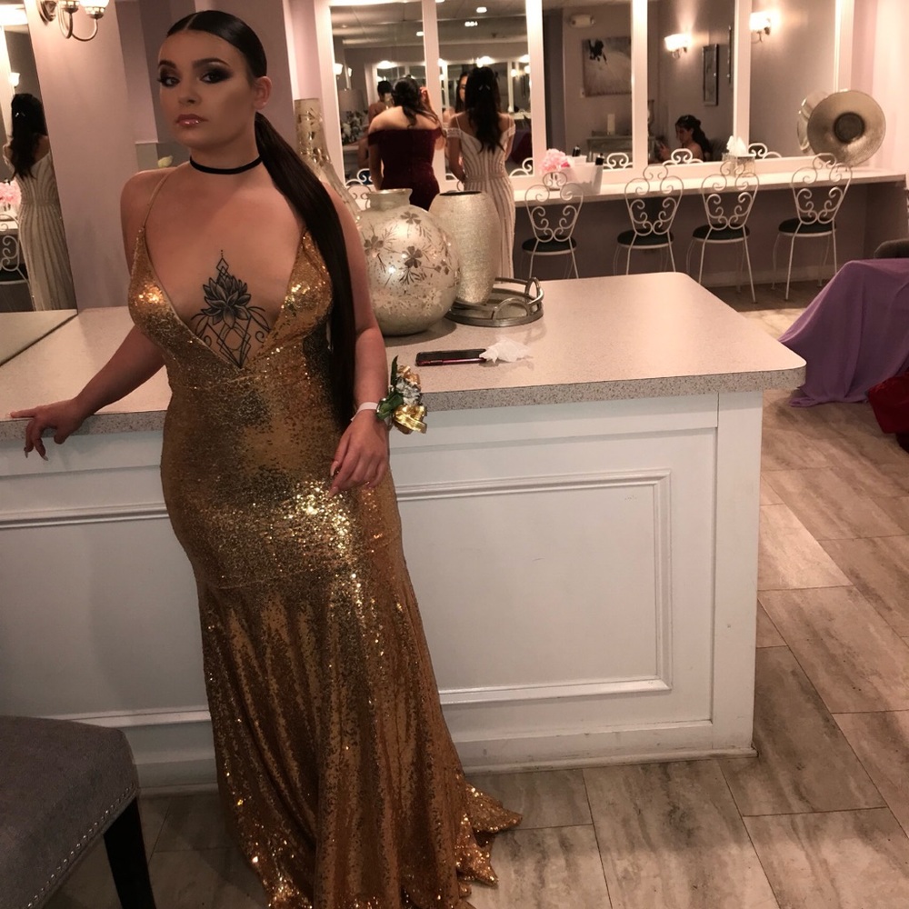 Long mermaid gold dress deep v cut in the front.